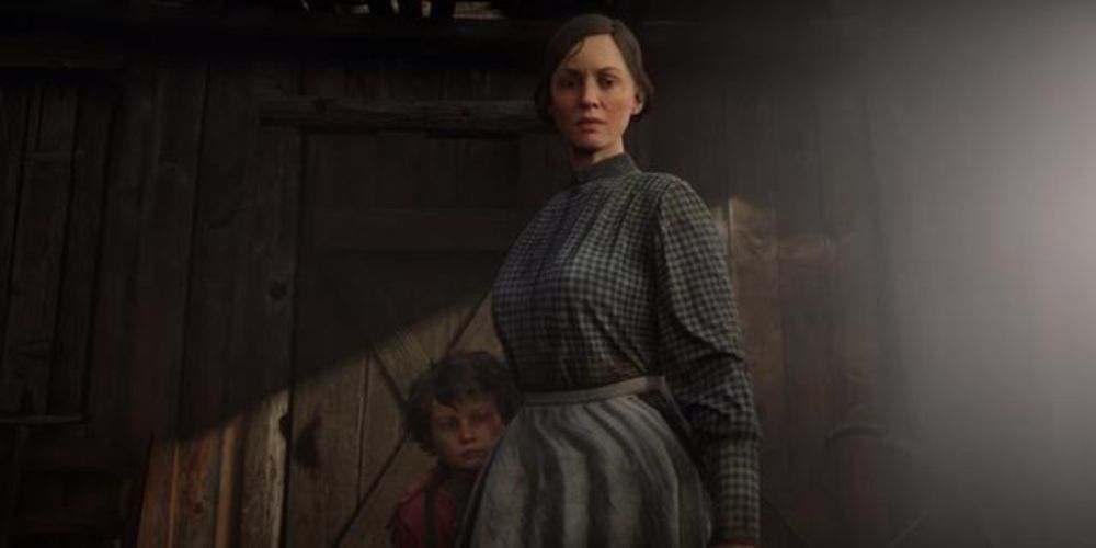 Red Dead Redemption 2 screenshot of Mrs Londonderry looking straight ahead with her kid behind her.