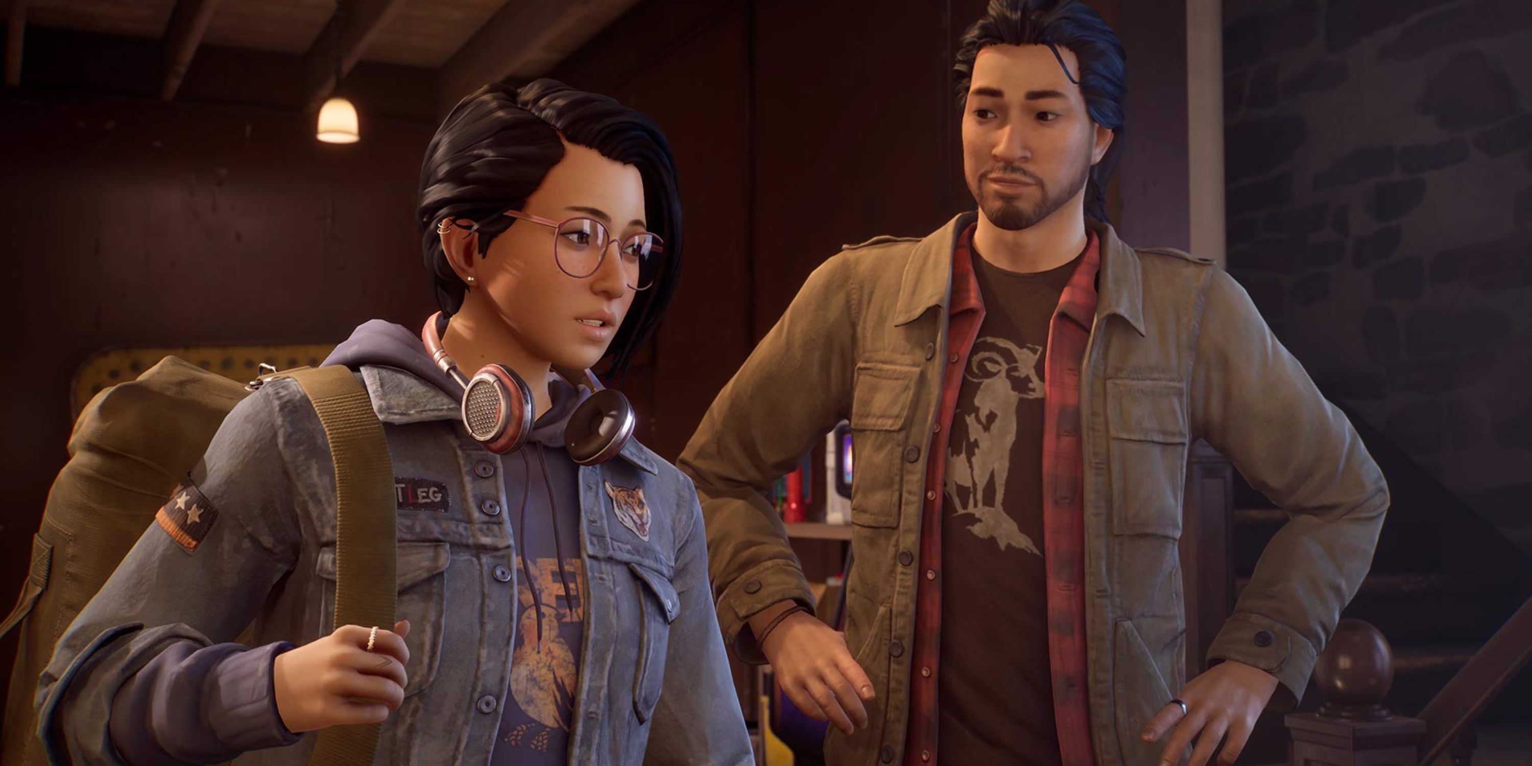 Alex and Gabe stand next to each other inside a building.