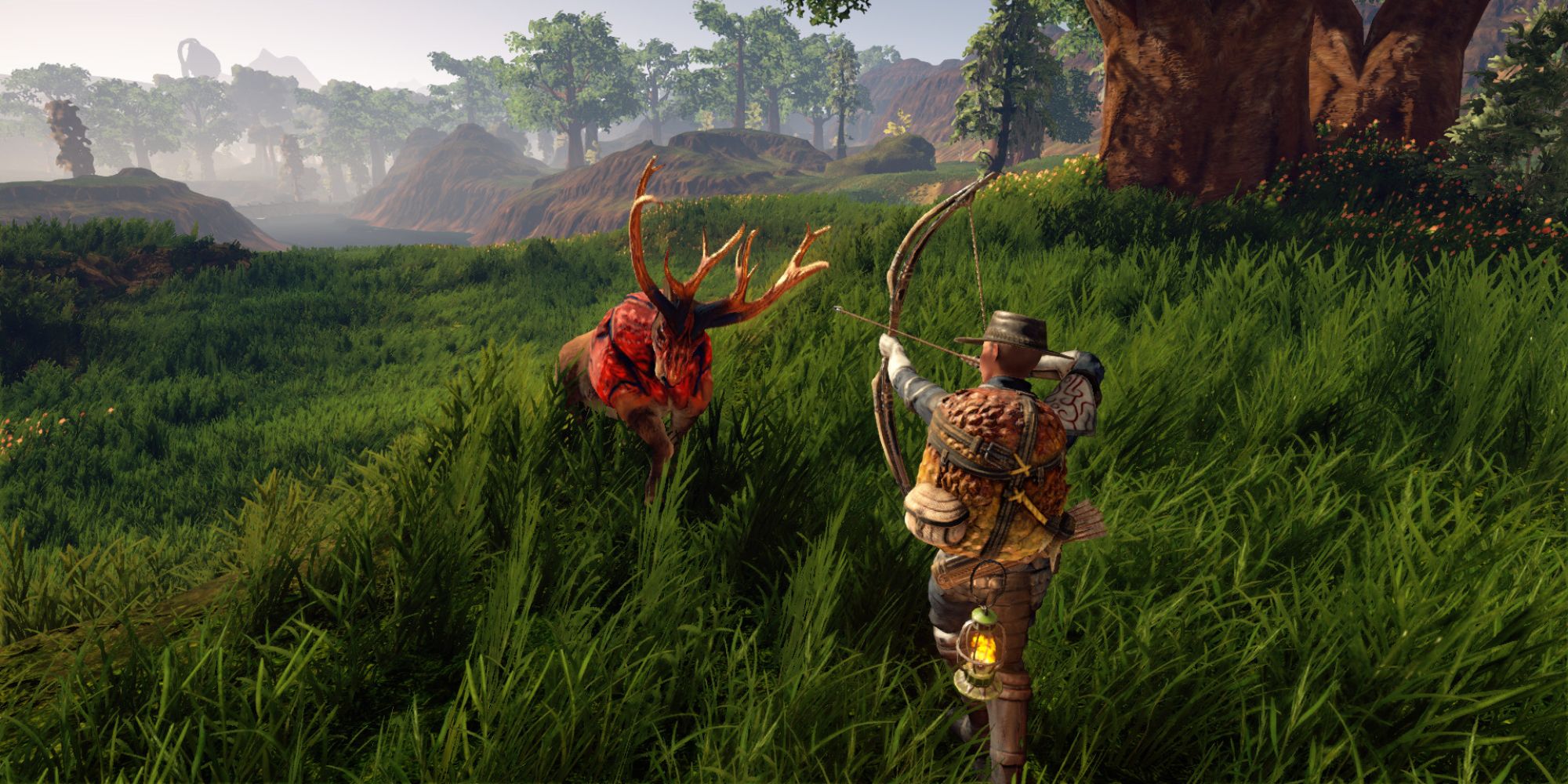 A wide shot of a hunter aiming their bow at an incoming red deer in a vast verdant valley filled with tall grass and trees.