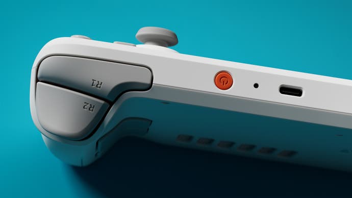 Promotional photo of the Steam Deck OLED: White Edition showing its shoulder triggers viewed from above.