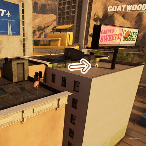 An orange arrow points the trophy that is on a roof with a candy ad signboard in Goat Simulator Remastered