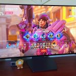 LG UltraGear 32GS95UE-B monitor on desk with Pharah from Overwatch 2 character select on screen