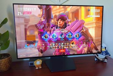 LG UltraGear 32GS95UE-B monitor on desk with Pharah from Overwatch 2 character select on screen