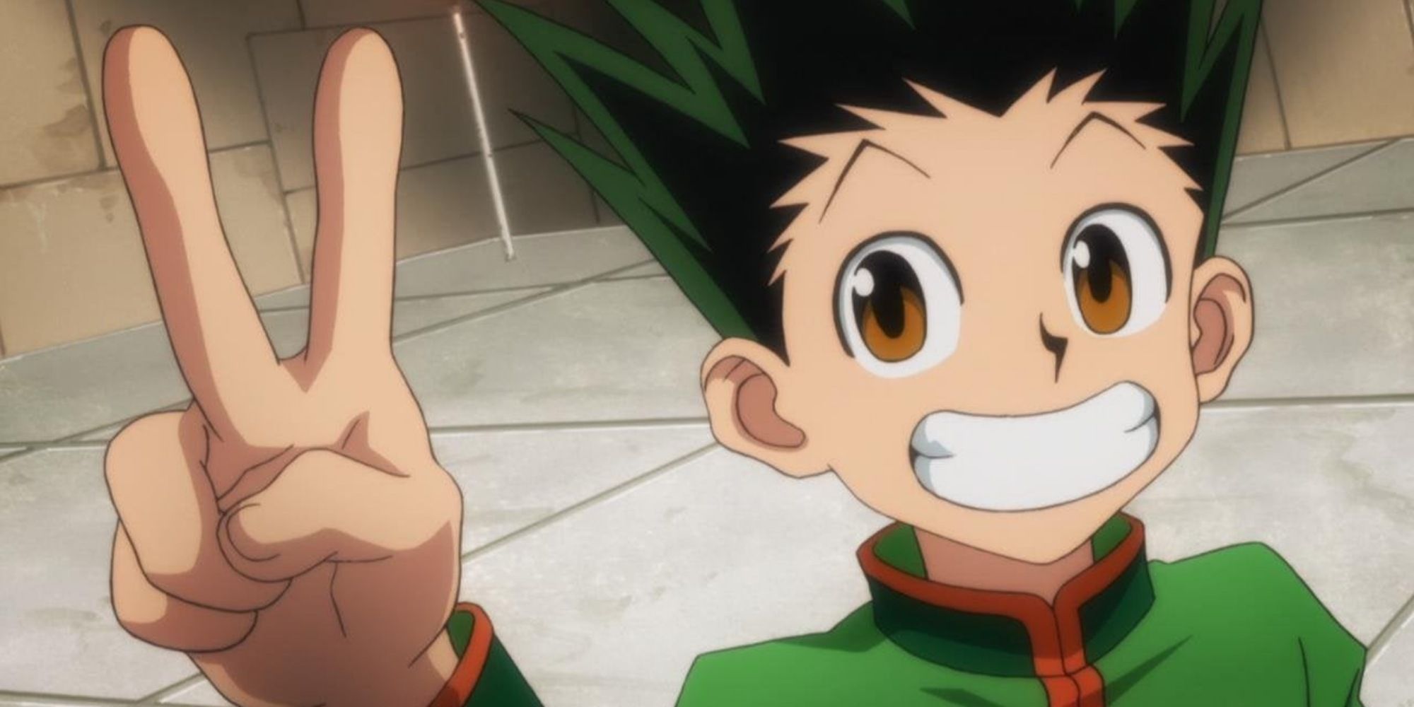 Gon Freecss smiling widely and holding a Peace sign