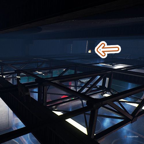 An orange arrow points the trophy that is on the scaffoldings inside a building in Goat Simulator Remastered