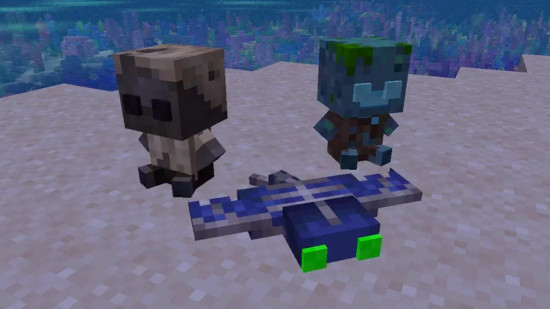 Three cute Minecraft mob plushies sit on the sand on the beach in one of the best Minecraft texture packs.