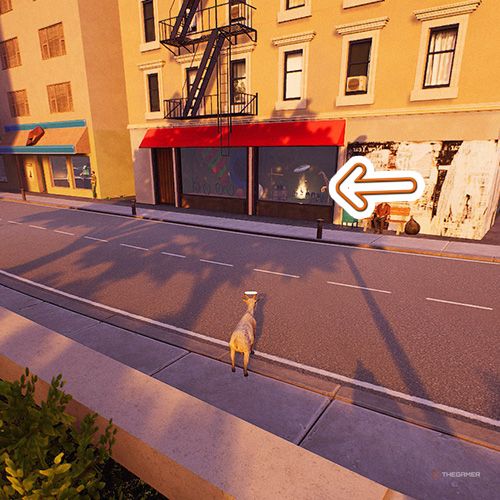 An orange arrow points the trophy that is inside a store with a red awning in Goat Simulator Remastered