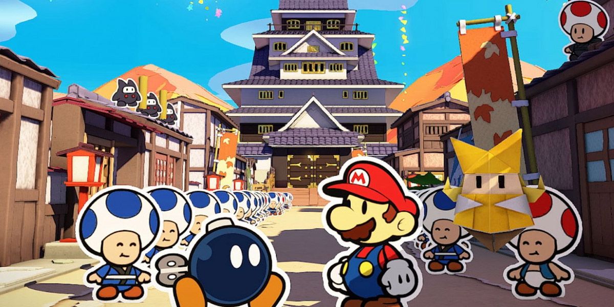 Paper Mario The Origami King: Mario and Bobby in front of a building with toads lined up outside.