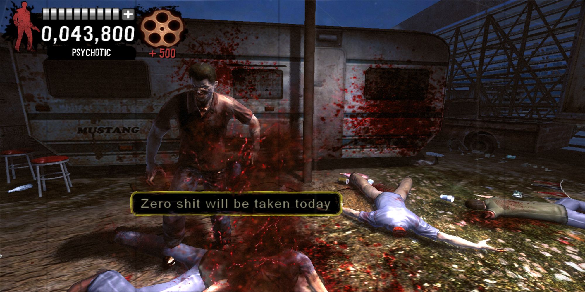 Agent G shoots a zombie with the phrase, "Zero Shit Will Be Taken Today," outside a trailer in a zombie carnival in  The Typing Of The Dead Overkill