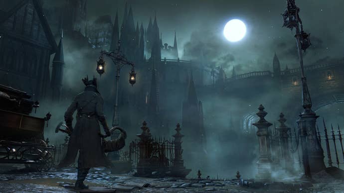 A hunter from Bloodborne stood on a Victorian-esque street at night, a full moon shining down on them.