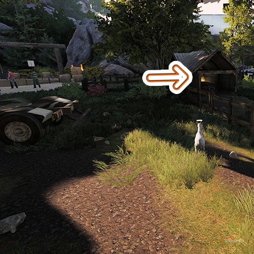 An orange arrow points the trophy that is inside a small hut in Goat Simulator Remastered