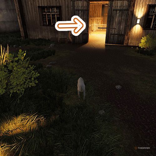 An orange arrow points the trophy that is inside an empty barn in Goat Simulator Remastered