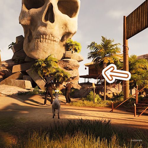 An orange arrow points the trophy that is inside of the hut next to a large skull statue in Goat Simulator Remastered