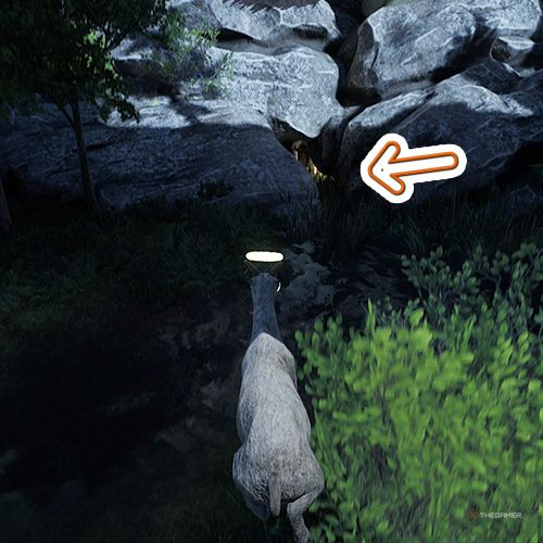 An orange arrow points the trophy that is inside a crack between the rocks in Goat Simulator Remastered