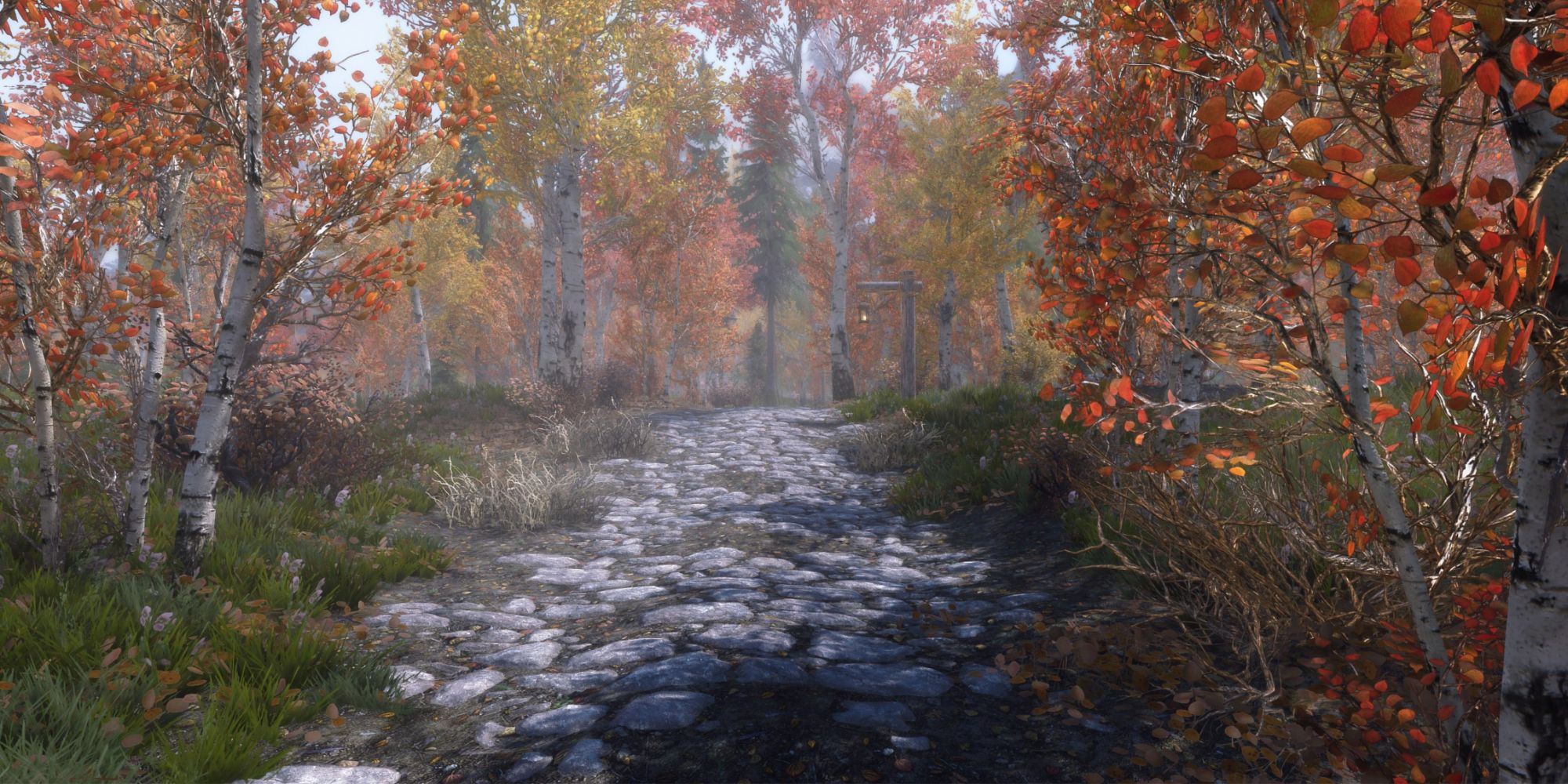 A cobblestone path surrounded by orange grass and trees in realistic graphics