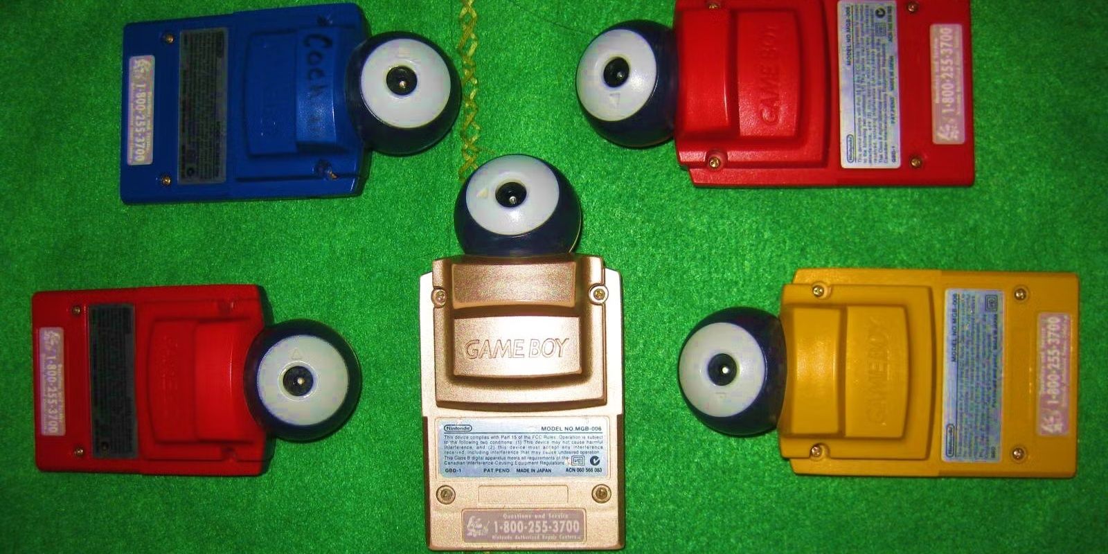 Image of multiple Game bBoy cameras, the one in the middle being the Ocarina of Time Gameboy camera.