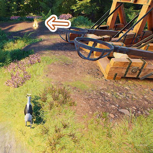 An orange arrow points the trophy that is next to two catapults in Goat Simulator Remastered