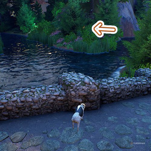 An orange arrow points the trophy that is hidden inside bushes where river branches splits in Goat Simulator Remastered