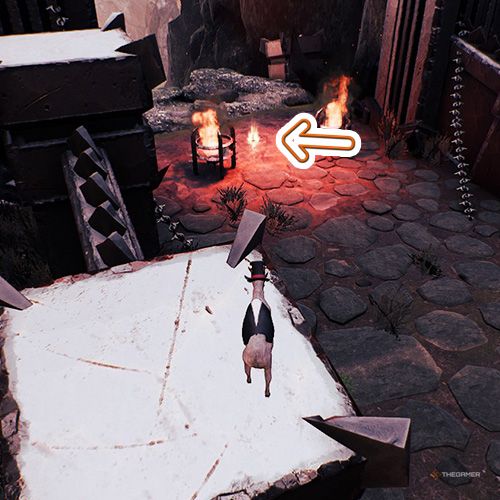 An orange arrow points the trophy that is between two braziers inside a castle in Goat Simulator Remastered