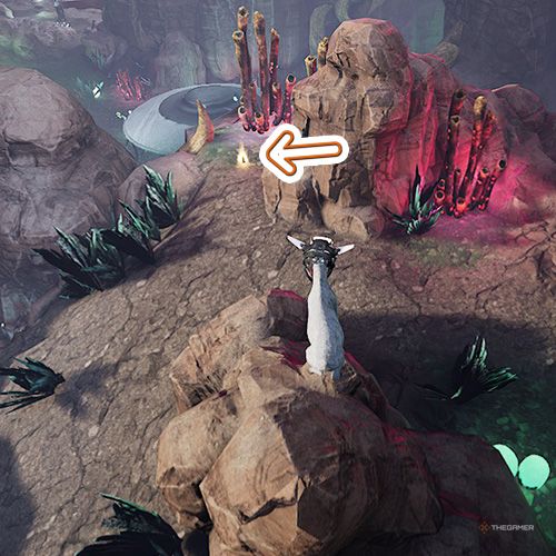 An orange arrow points the trophy that is behind a rock inside the Alien Infestation area in Goat Simulator Remastered