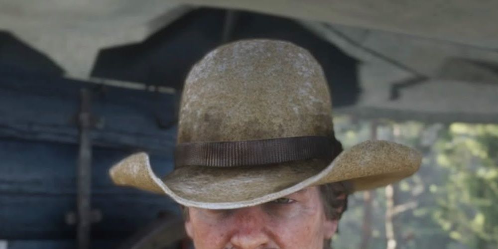 Arthur showing off a Liberty Hat in Red Dead Redemption 2 the video game.