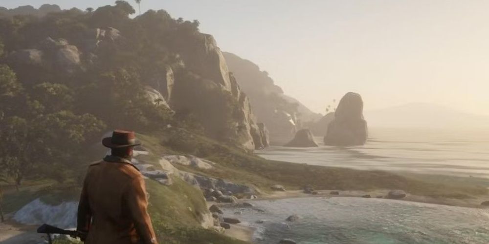 Aruthur looking into the ocean from a cliff in Guarma in Red Dead Redemption 2 the video game.