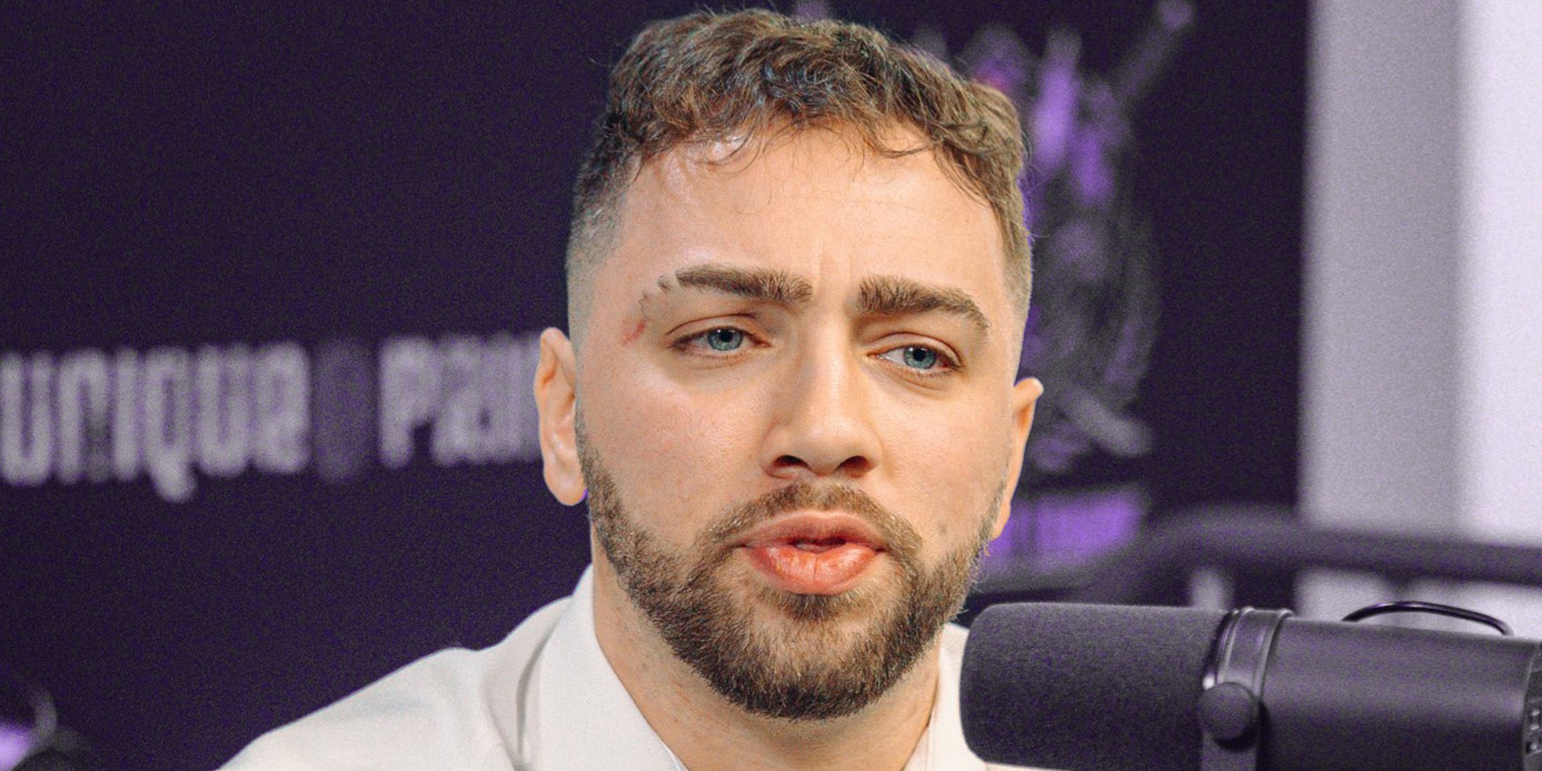 Mizkif in front of microphone purple background 2x1 composite