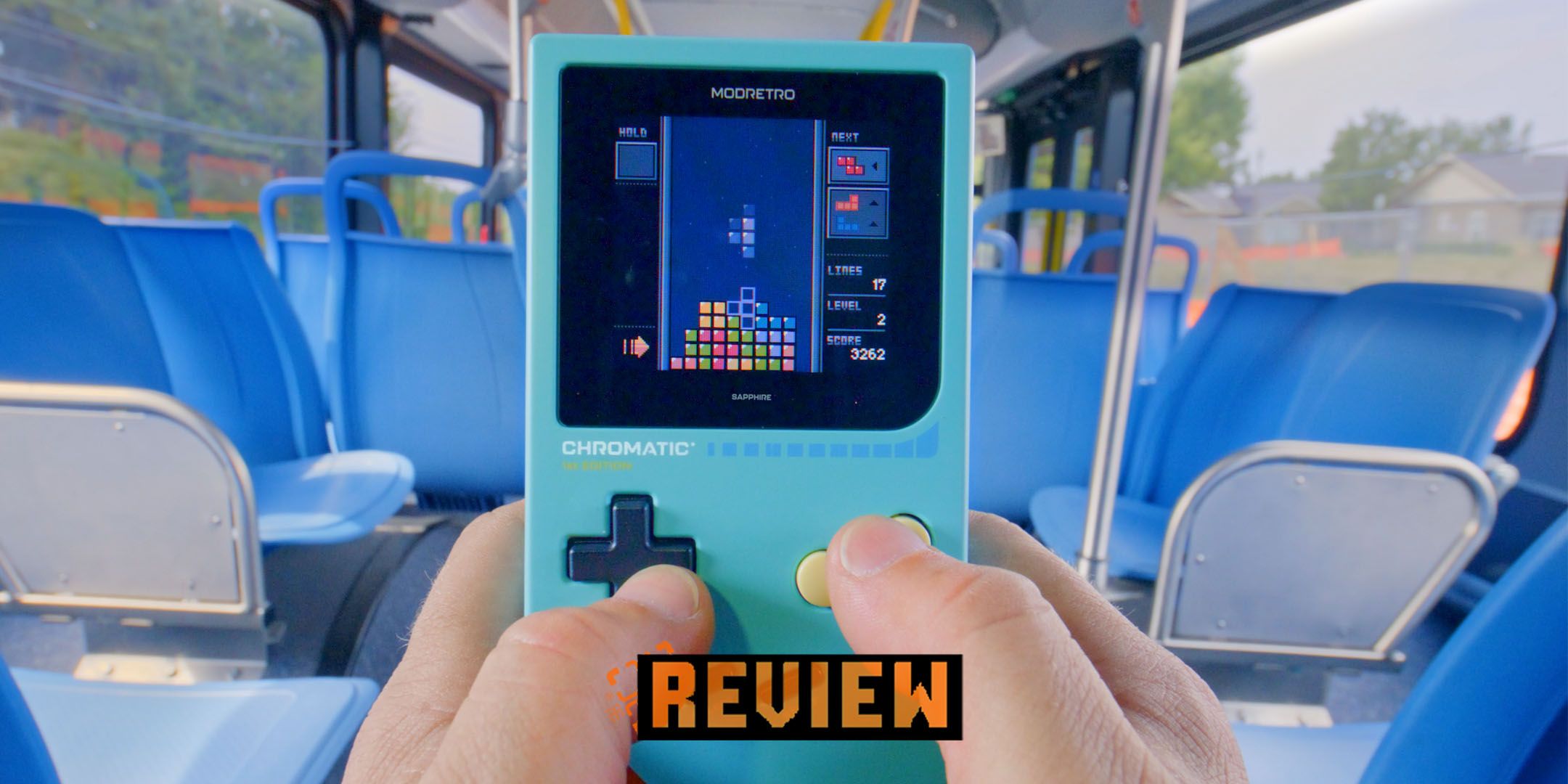 ModRetro Chromatic handheld being played on a bus.