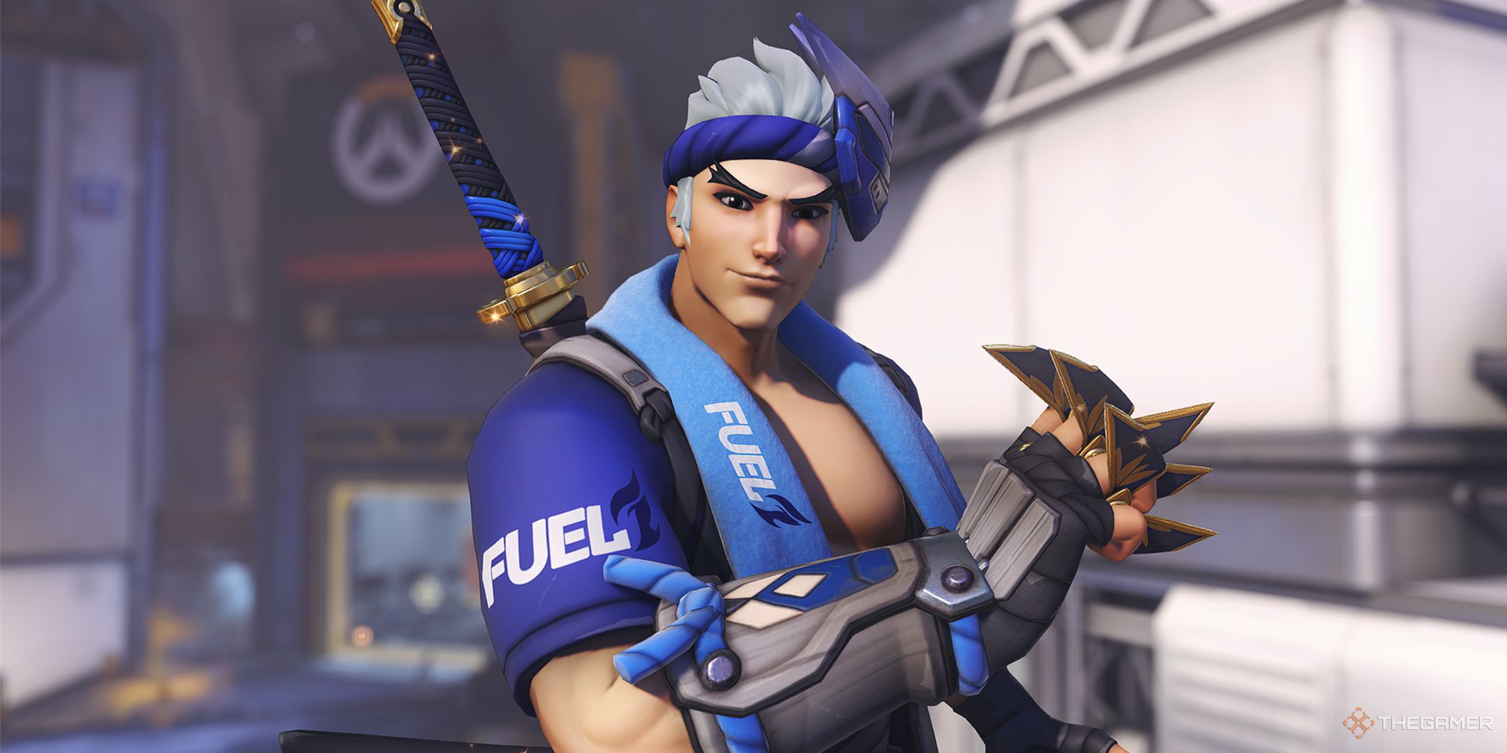 Genji in his Dallas Summer League Skin wielding golden shuriken on the hero select screen.