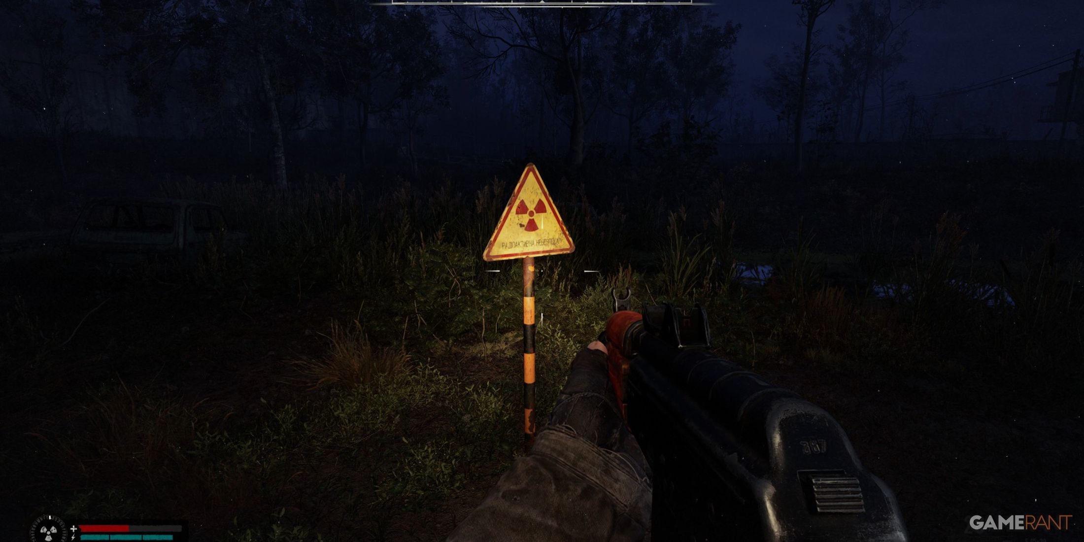 A radiation warning sign illuminated by a flashlight at night, with a rifle in view in STALKER 2