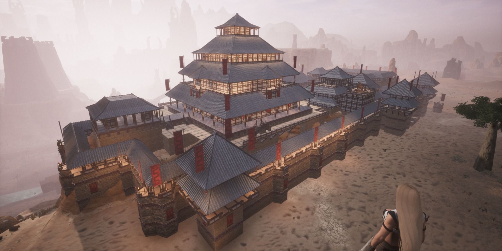 Conan Exiles screenshot of large building with red flags all over it.