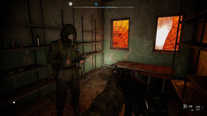 A Stalker uses his PDA while waiting out an Emission indoors, as the windows glow orange behind him in Stalker 2: Heart of Chornobyl.