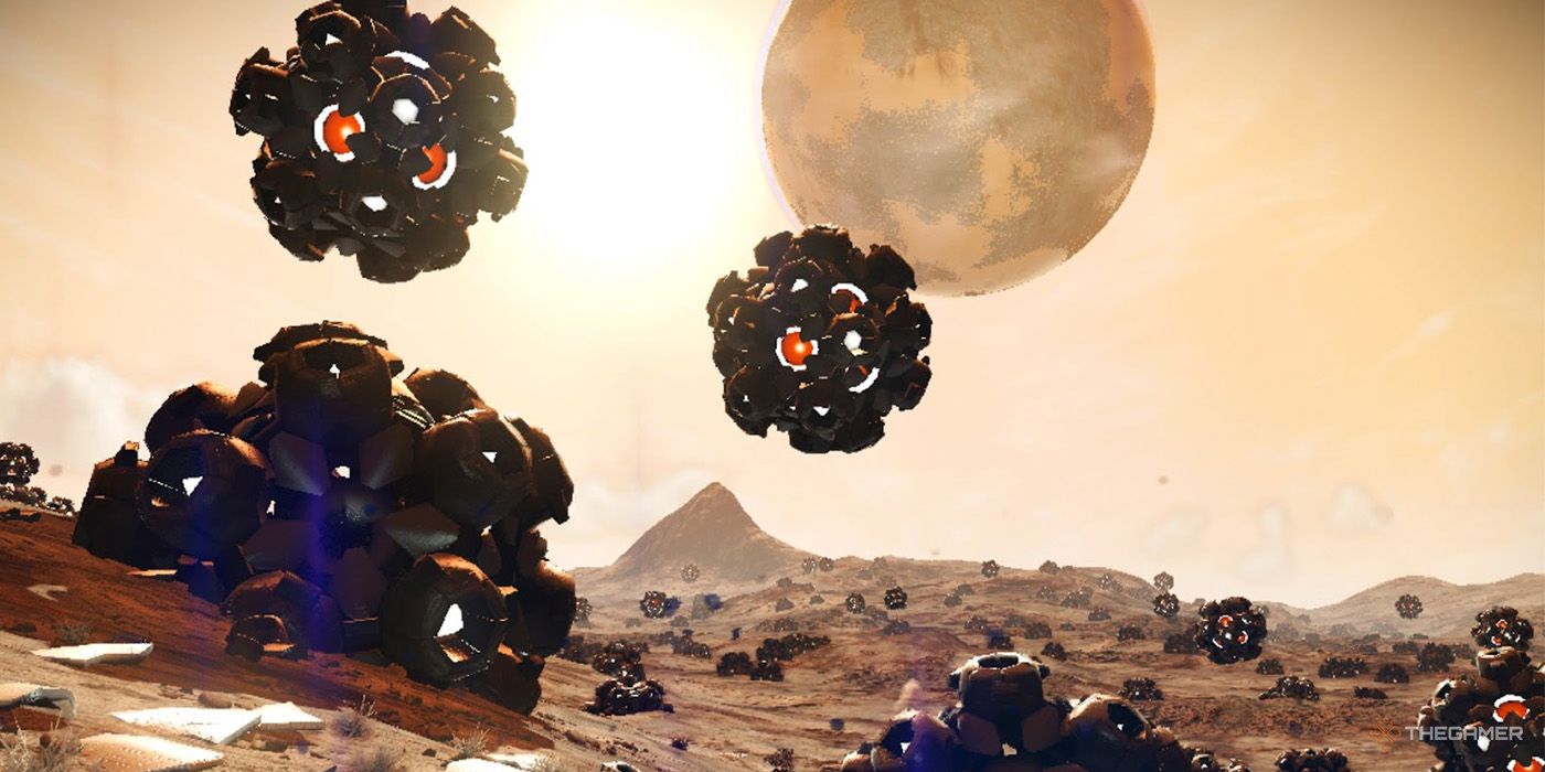 Assorted metallic objects dot the landscape of a fract cube planet in No Man's Sky.