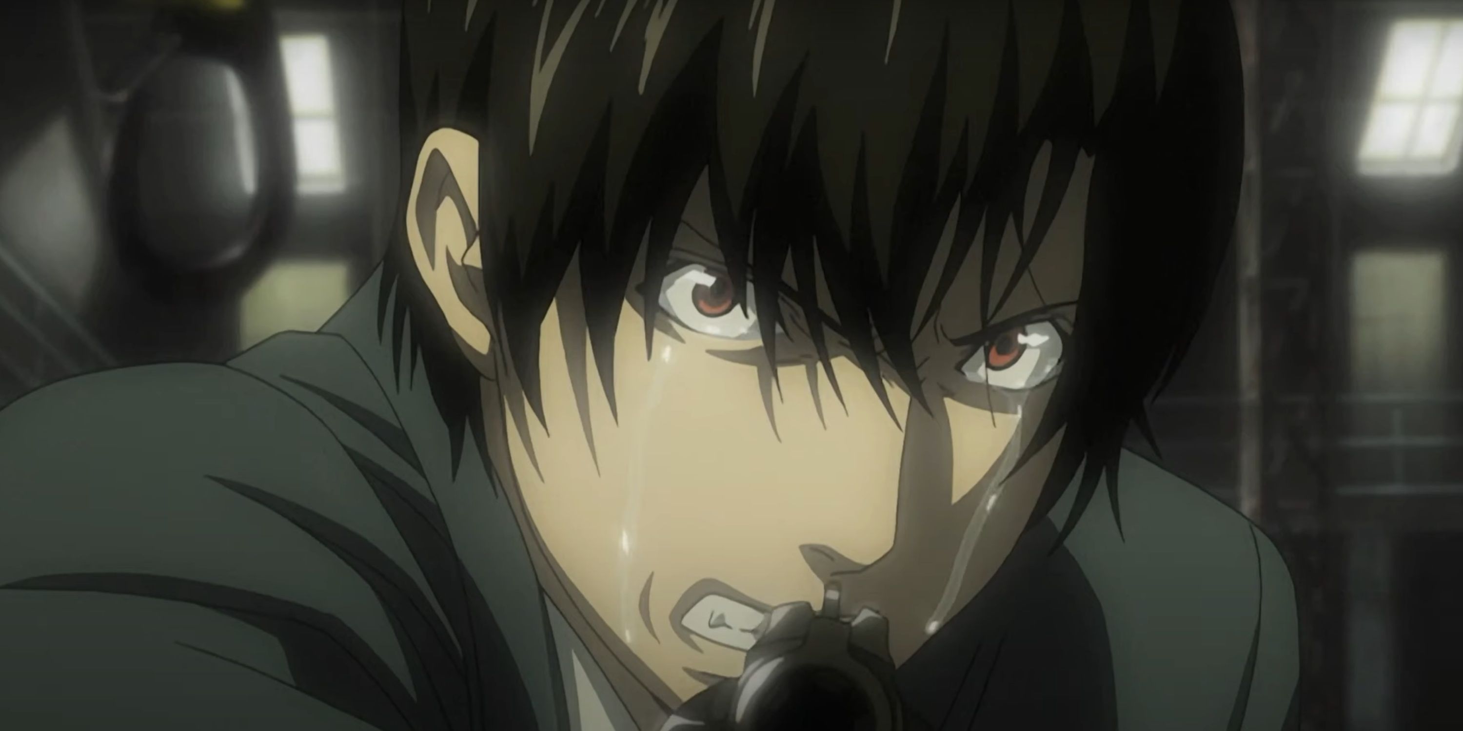 Touta Matsuda cries as he aims his gun in Death Note.