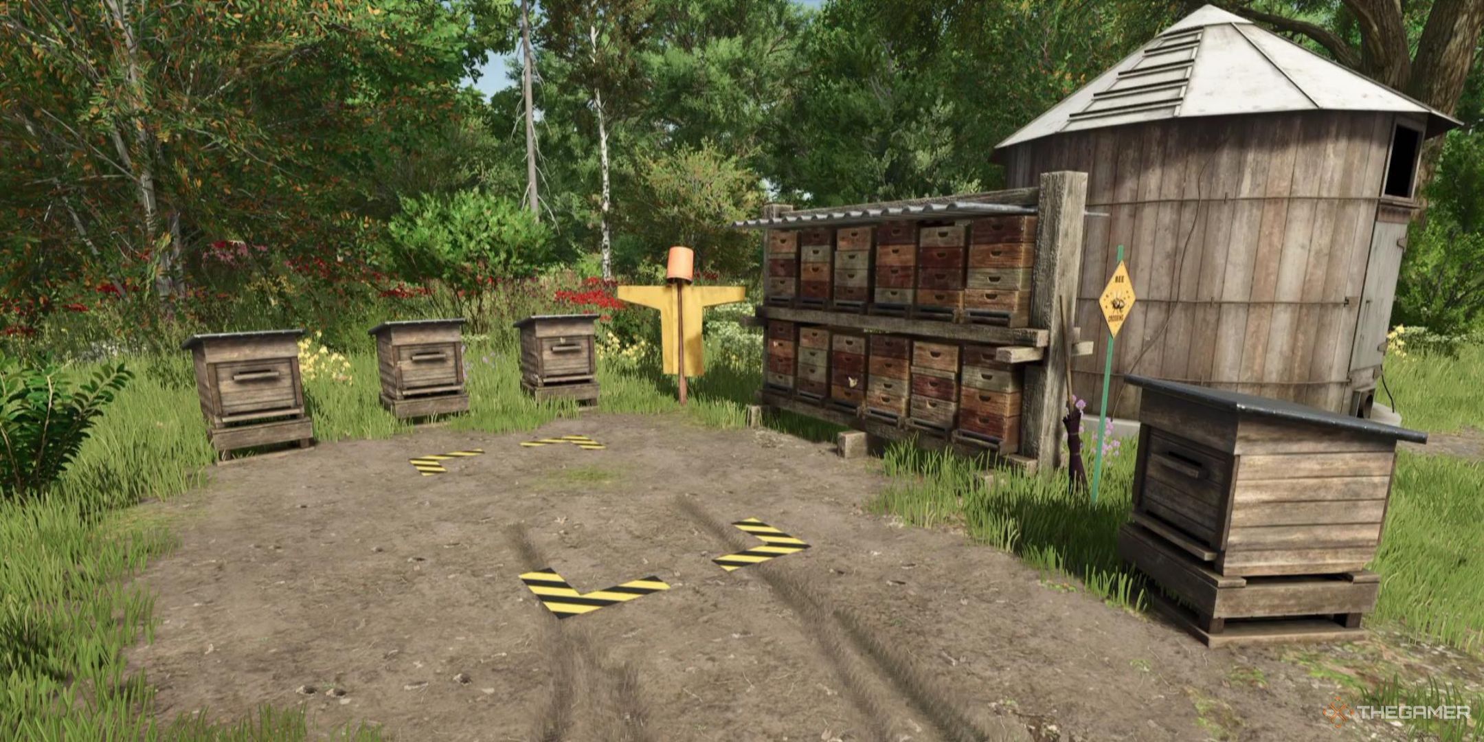 Beehives, a small silo, and a honey collection area are all clustered together in Farming Simulator 25.