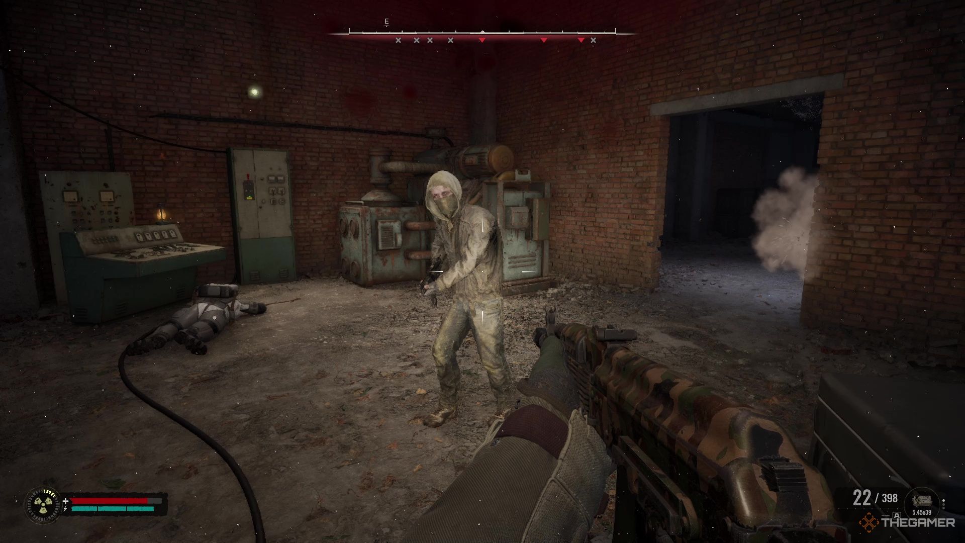 A zombie stands in an industrial room to attack the player in Stalker 2 Heart of Chornobyl.