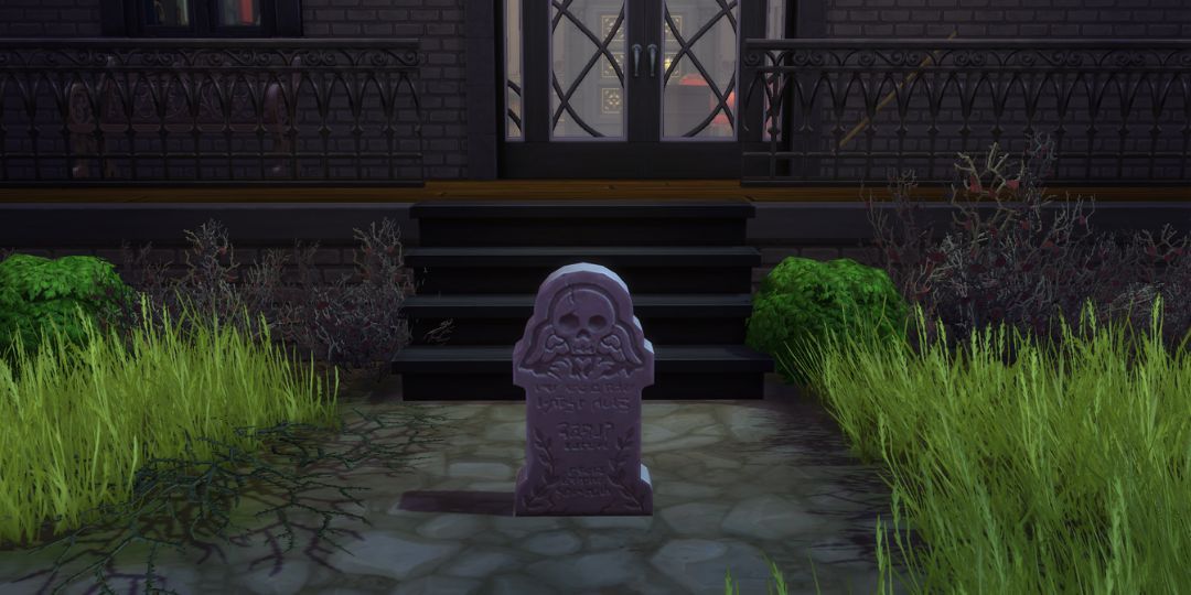 A gravestone with a prominent skull sits on the ground.