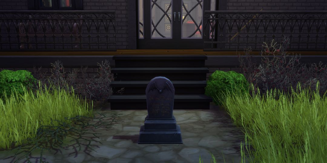 A plain black grave with a vampire bat carving sits on the ground.