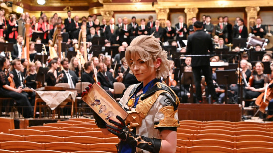 A cosplayer poses with an Impact4Music: Diversity in Harmony concert programme in hand, the orchestra on-stage behind them.