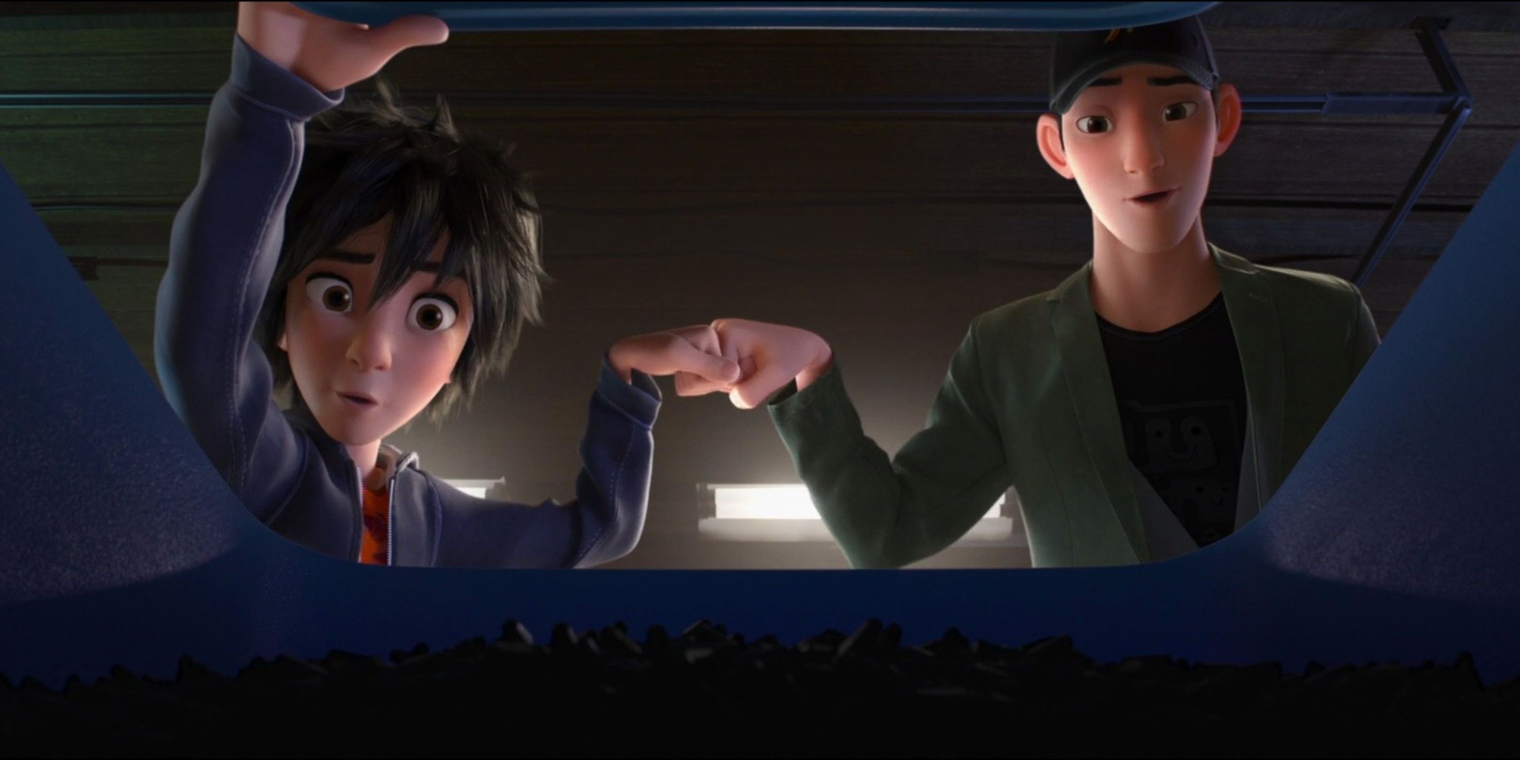 Hiro and Tadashi fist bump in Big Hero 6.