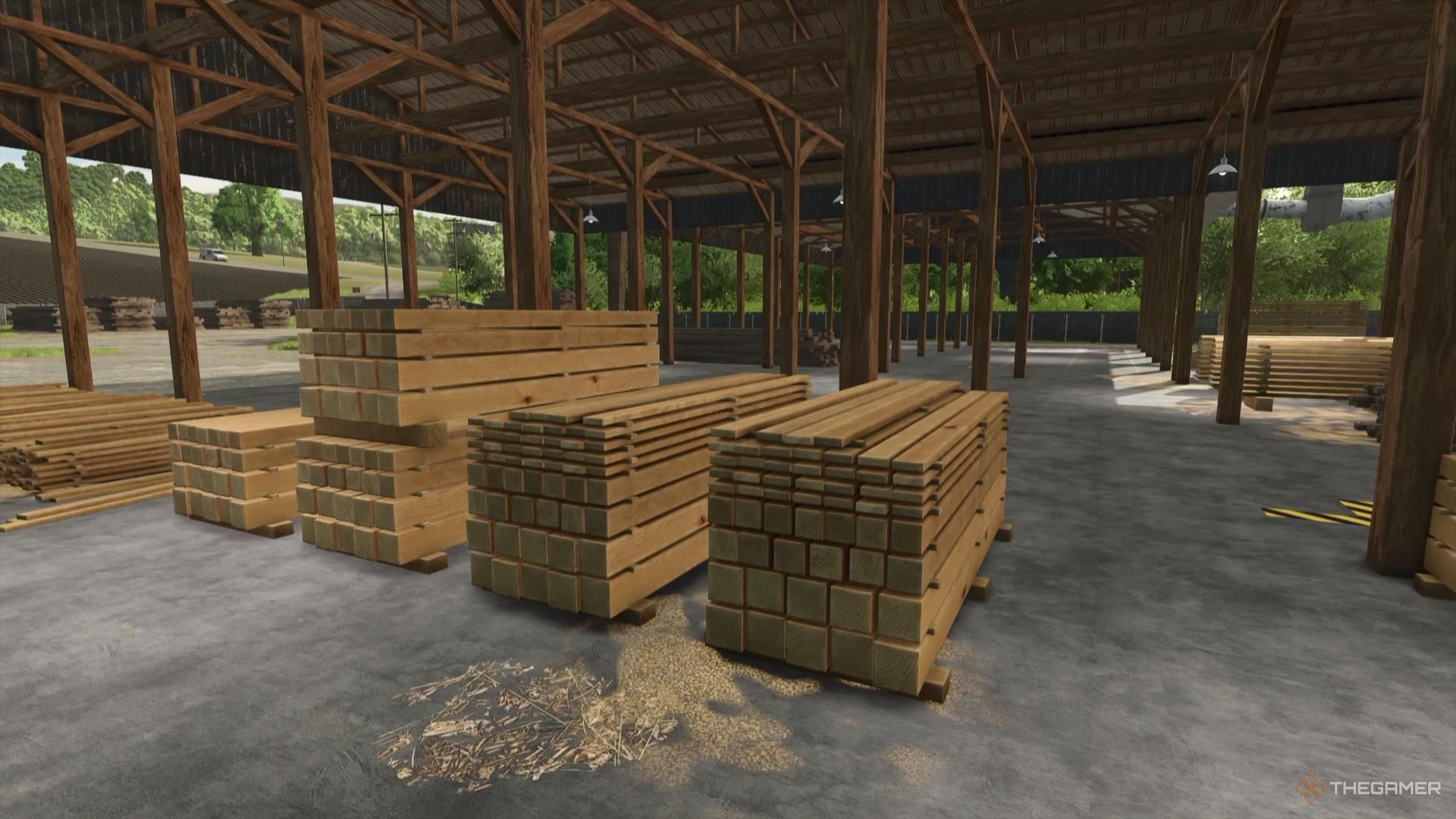 Freshly-cut wooden planks sit in a sawmill in Farming Simulator 25.