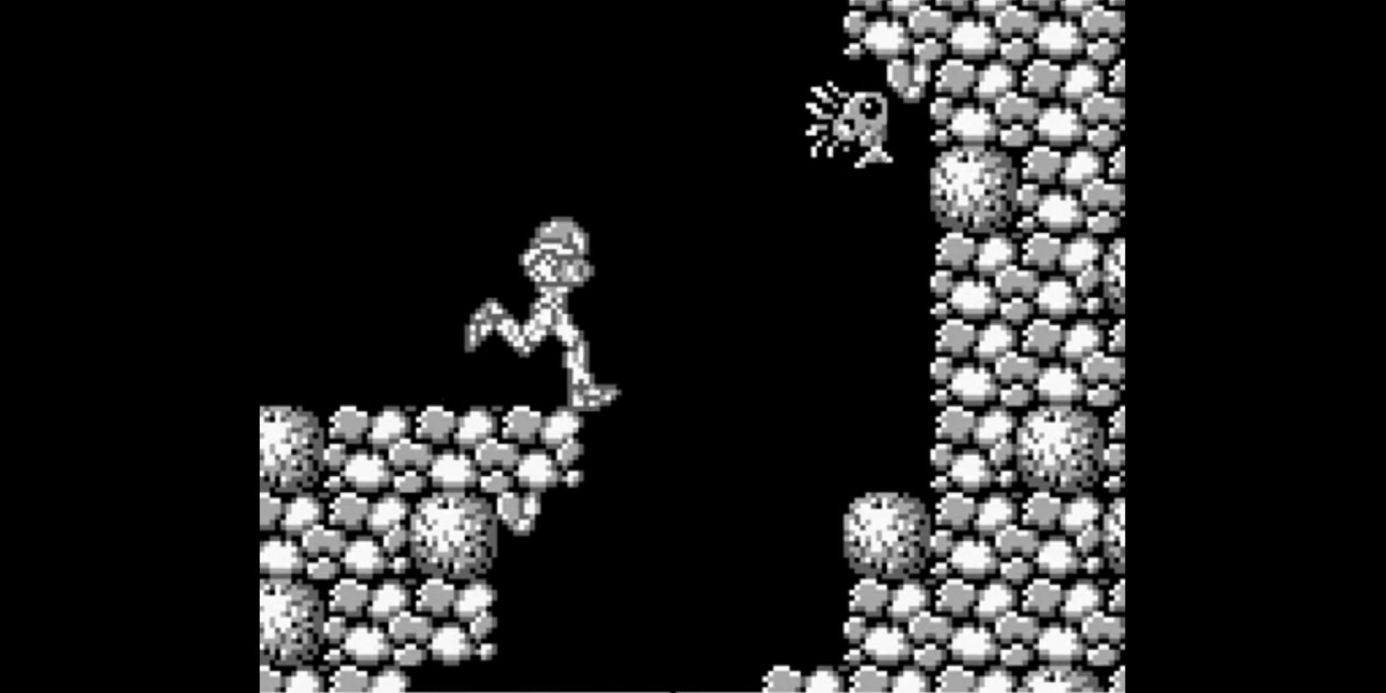 Samus runs toward a hole in the floor in Metroid 2: Return of Samus.