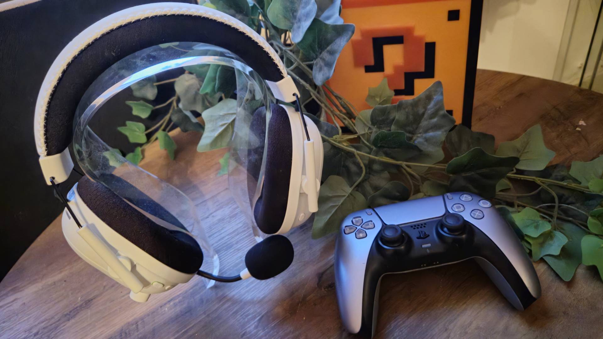 Image of the white version of the Razer BlackShark V2 Pro headset and a PS5 DualSense controller.