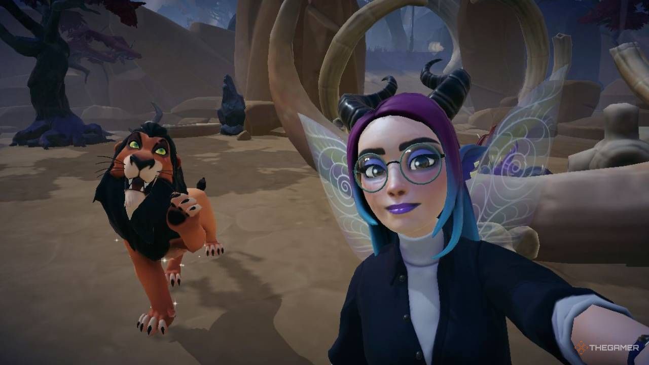 Disney Dreamlight Valley avatar taking a selfie with Scar on the left of the image. Scar's house and large bones can be seen behind the avatar, and the entrance to the Forgotten Lands is shown in the distance.