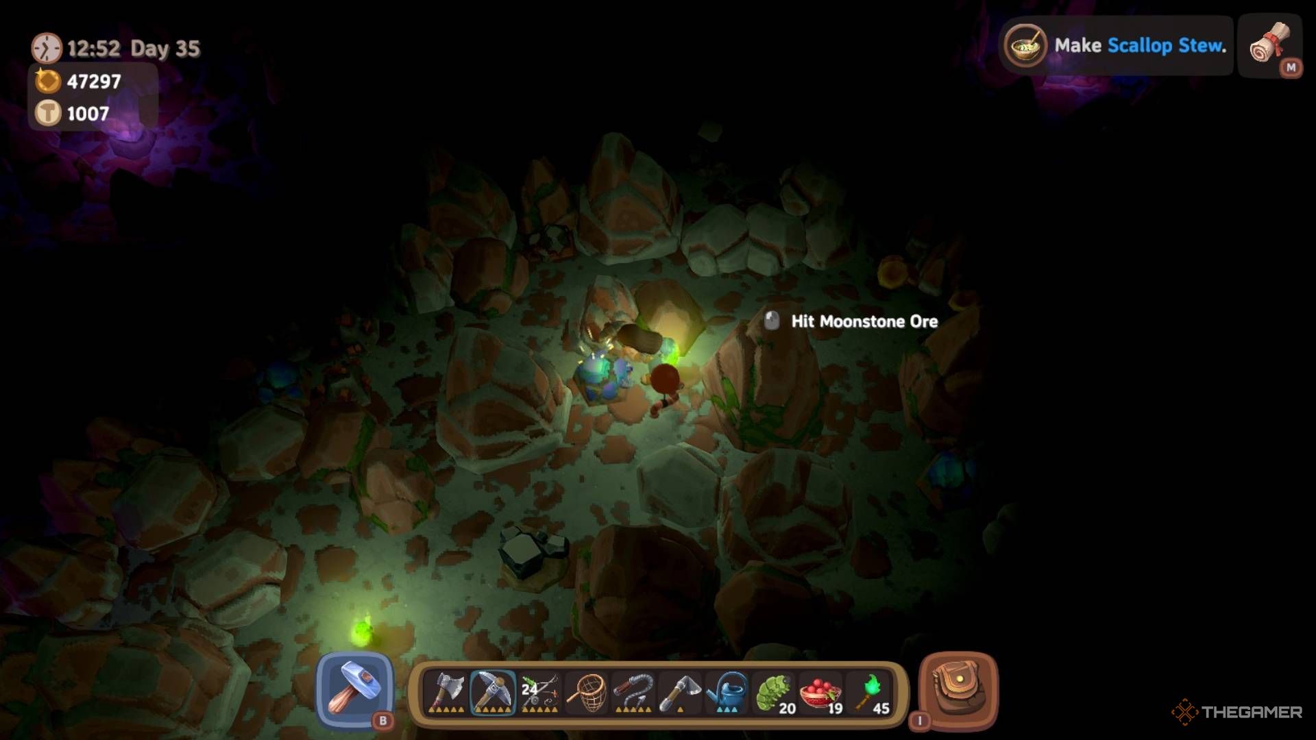 Player character mining Moonstone Ore while lit up by green torches in a dark cave in Luma Island.