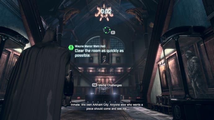 The main foyer of Wayne Manor in Batman Arkham City. Text reads 