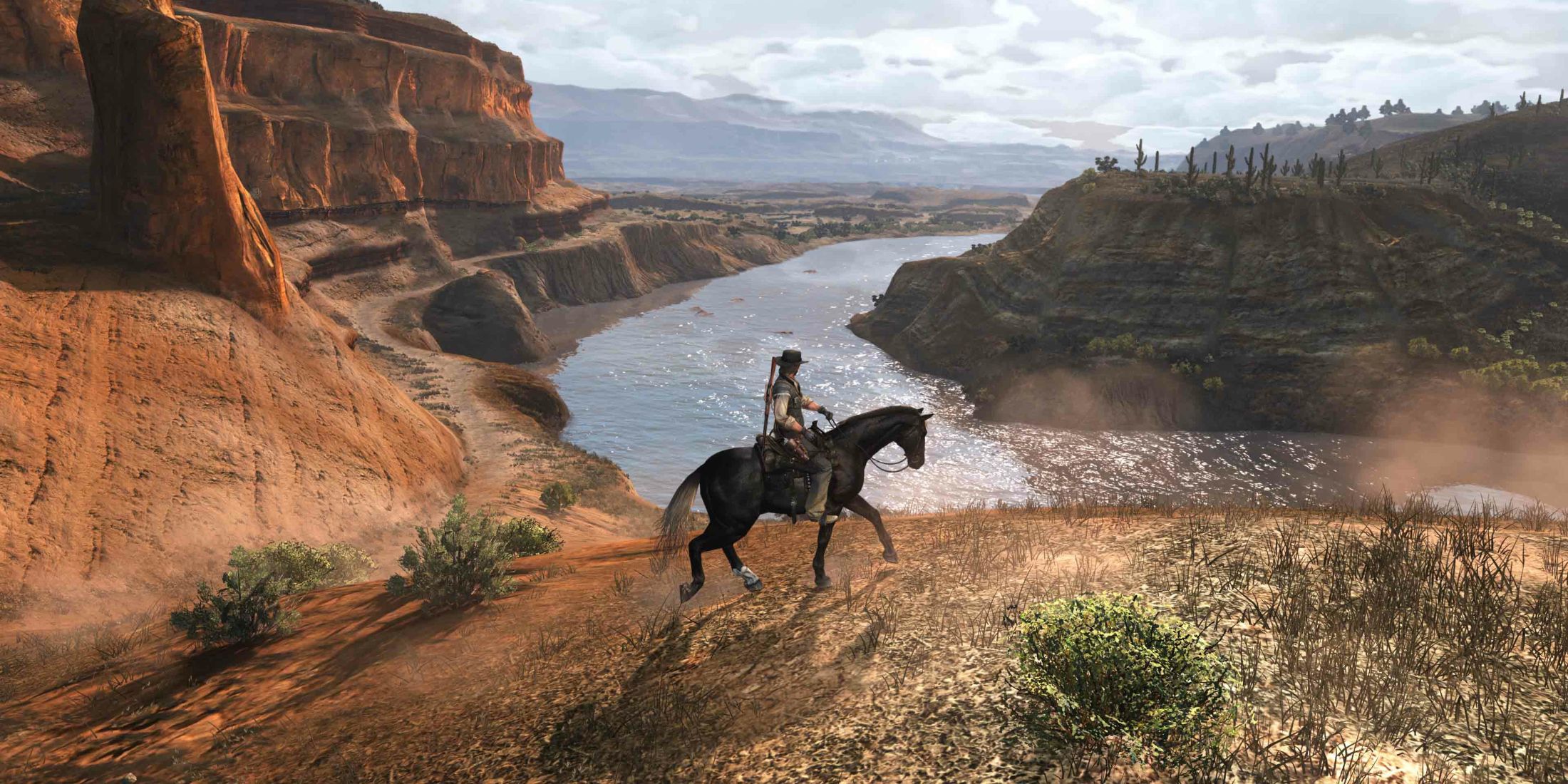 John Marston riding his horse through a valley overlooking a river in Red Dead Redemption