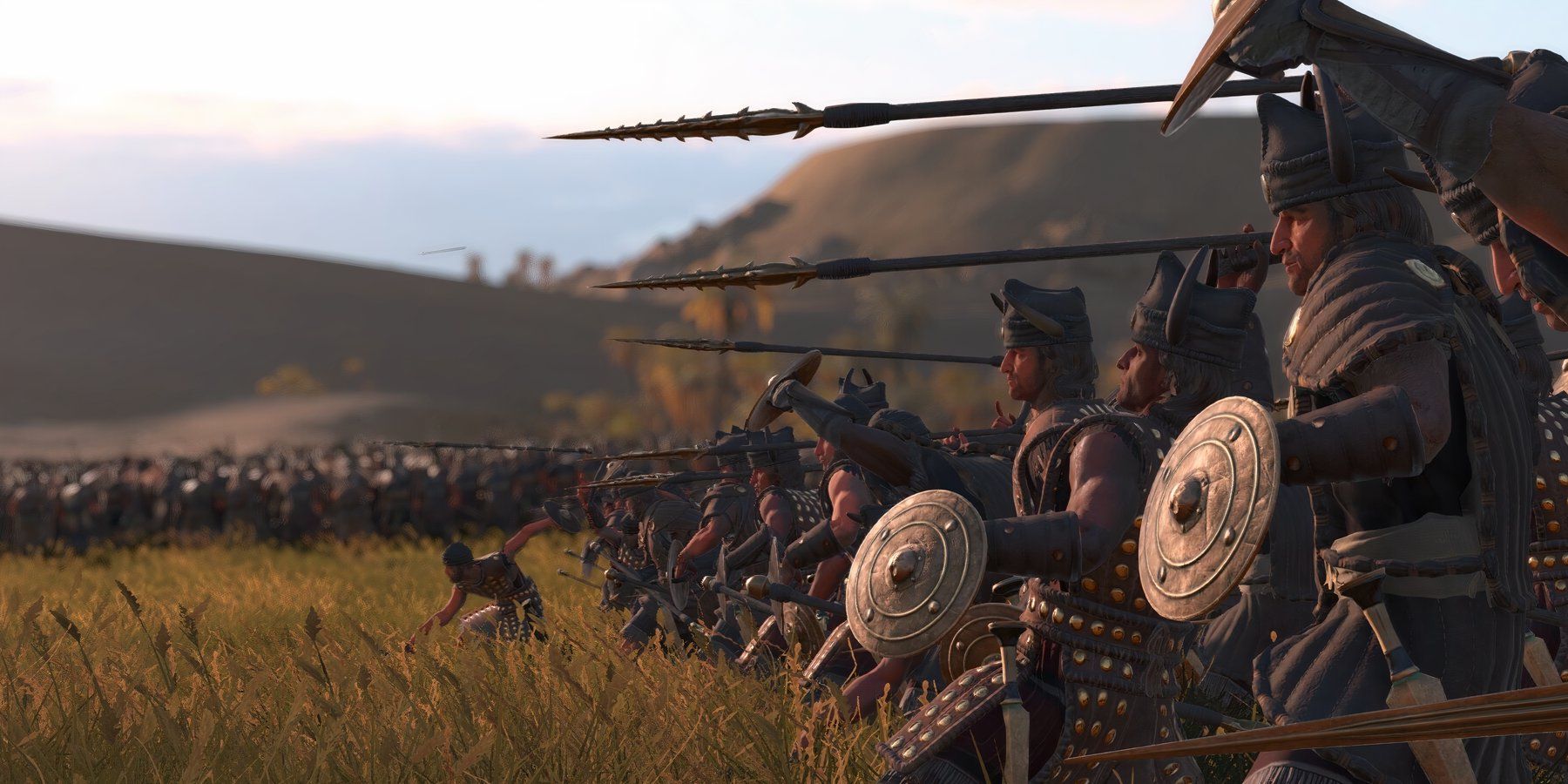 Total War Pharaoh gameplay with forces on the brink of battle with heavy armor, weapons, and shield.