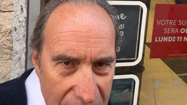 Xavier Niel takes a picture of himself outside a supermarket. 