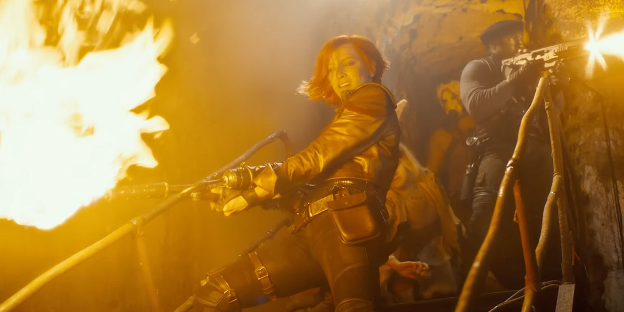 Lilith in the Borderlands movie firing a flamethrower while walking downstairs in front of Roland